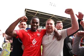 Gavin Massey celebrates with the Latics fans after the victory at Shrewsbury in 2022 that secured the League One title