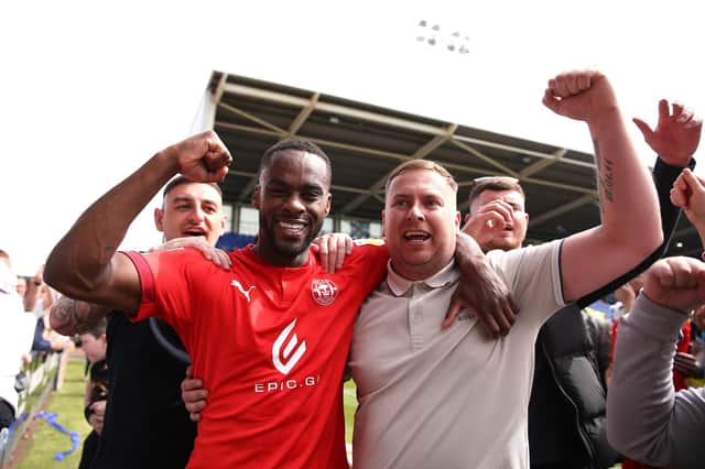 Gavin Massey celebrates with the Latics fans after the victory at Shrewsbury in 2022 that secured the League One title