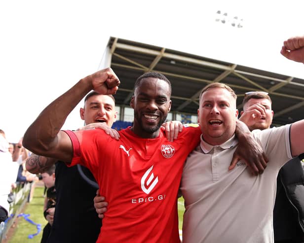 Gavin Massey celebrates with the Latics fans after the victory at Shrewsbury in 2022 that secured the League One title
