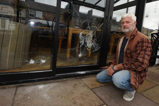 Craig Jones, owner of The Hoot, Standish, looks at the damaged caused by the break-in