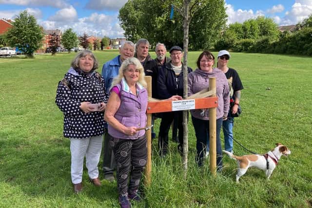 The community group known as Friends Around Bryn with one of the trees planted.