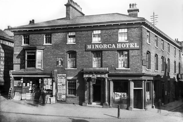 The Minorca Hotel which stood at the corner of King Street and Wallgate pictured in the late 1890s.
On the left is the Wigan Observer Office and Stationery House with various placards advertising the Leeds Mercury, Liverpool Courier, Tit Bits, Cassell's Saturday Journal, Halfpenny Novelette, Penny Illustrated Paper, Bradshaw's Railway Guides, Manx steamer trips and even Mediterranean pleasure cruises.
Above is T.B.Rowe solicitor and Wigan Starr-Bowkett building societies with Rothwells grocers on the left.

