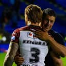 Wigan Warriors coach Matt Peet celebrates their his side's victory over Warrington Wolves with Adam Keighran