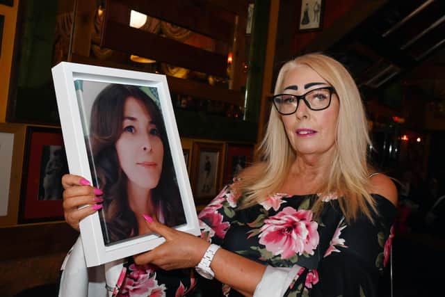 Gill Webster with a photograph of her daughter Laura Hazeldine, one year after her death