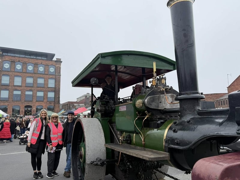 Cameron Stephenson with the organisers of the event and one of his steam engines