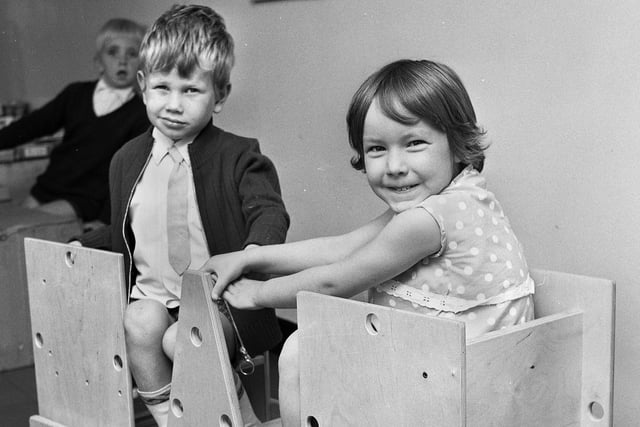 Keith Holden, five, and Deborah Gaskell, four, in a rocking boat which they helped to make from a kit at Pemberton Primary School in September 1971.