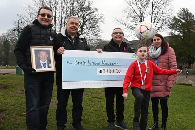 Finley McKeown is congratulated for his fund-raising efforts by Manny Flores, holding a photograph of his best friend Sam Smyth, councillors Ron Conway and Chris Ready, and his mum Beky McKeown