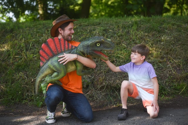 Devon McCarthy-Scarsbrook meets one of the dinosaurs and his keeper Will Stephens.