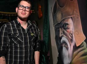 Cultural development officer Garry Lally next to artwork of Brian Boru