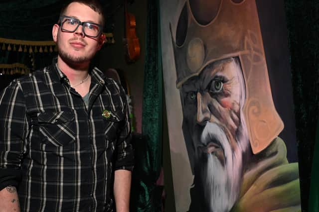 Cultural development officer Garry Lally next to artwork of Brian Boru