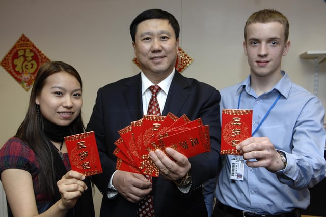 Wigan and Leigh College held a Chinese New Year dinner with guests from China and international and local students. Pictured with lucky red envelopes are Burmese student Nan Lin, Wang Gouping and Lawrence Paddern