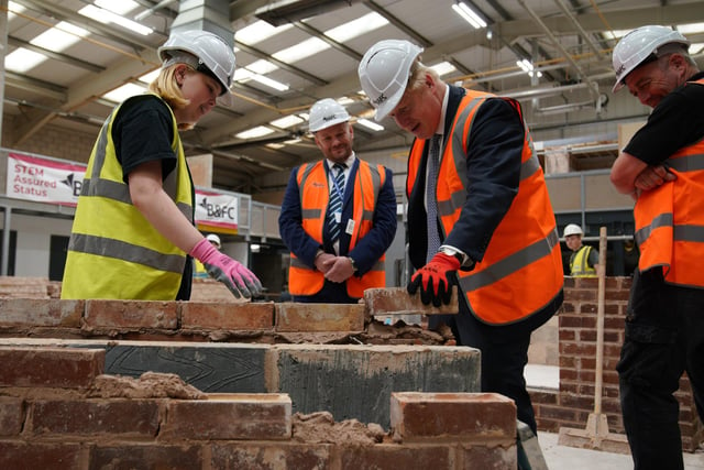 Prime Minister Boris Johnson takes part in a brick laying lesson at Blackpool and The Fylde College