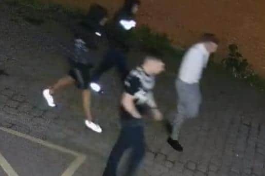 A CCTV still of four men police would like to question in connection with an attack in Bryn