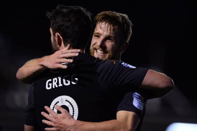 Michael Jacobs celebrates with Will Grigg during his hugely productive spell at Wigan