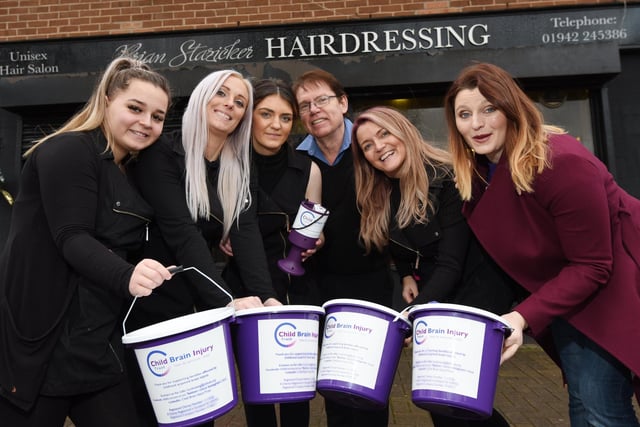 Event organisers and staff at Brian Stazicker hairdressing, Alyssa Thomas, Louise Perry, Olivia Connell, Brian Stazicker and Lisa Stazicker, present a £3,200 cheque to Danielle Gibson, right, fund-raising manager at Child Brian Injury Trust,  after they held a charity casino night