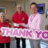 Christine Gorton handing the £1000.00 cheque to Chris Swinton the Events Fundraiser at Wigan and Leigh Hospice