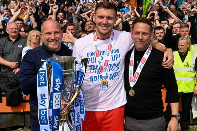Charlie Wyke (centre) with Dr Jonathan Tobin (left) and Leam Richardson (right), then Wigan Athletic manager, who helped save his life