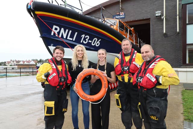 Megan and Brogan Griffiths with an RNLI crew from New Brighton
