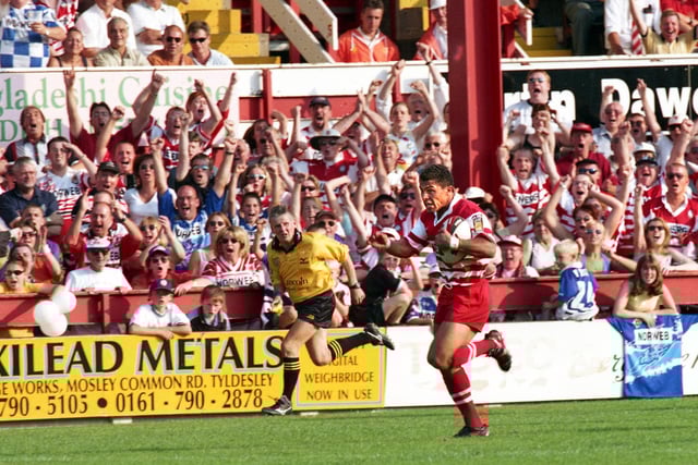 Wigan fans erupt as winger Jason Robinson scorches in for one of his two tries against St. Helens.