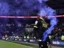 Miguel Azeez picks up a flare at Cardiff, which earned him a one-match ban from the FA