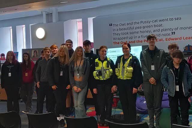 Community support officers with some of the students who attended their talk at Wigan Library