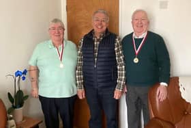 Coun Ron Conway presents the medals to the brothers