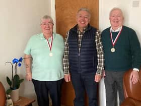 Coun Ron Conway presents the medals to the brothers