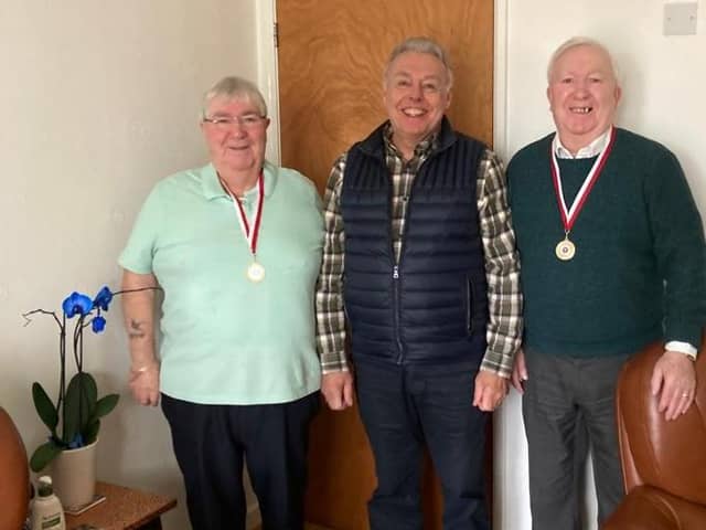 Coun Ron Conway presents the medals to the brothers