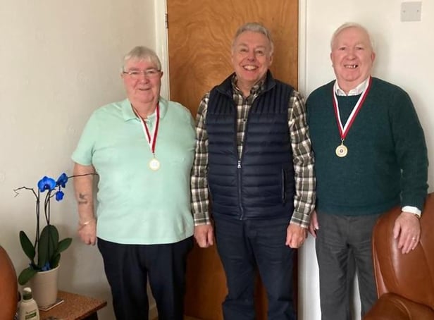 Coun Ron Conway presents the medals to the brothers