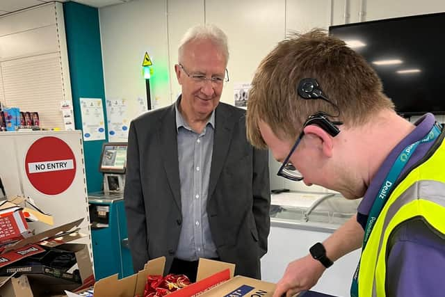 Wigan Council leader Coun David Molyneux watches a trainee from The Hamlet at work