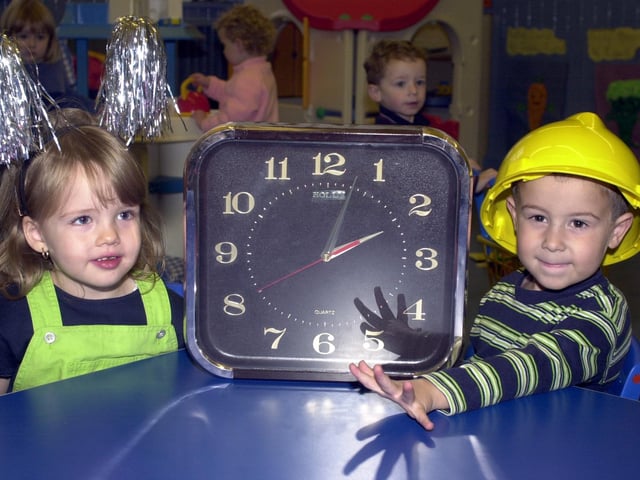 Laura Slater and Joseph Gaskell from Kids.com Nursery at Springfield getting the class clock ready in 2000