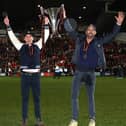 Rob McElhenney and Ryan Reynolds, the owners of Wrexham, celebrate with the Vanarama National League trophy