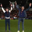 Rob McElhenney and Ryan Reynolds, the owners of Wrexham, celebrate with the Vanarama National League trophy