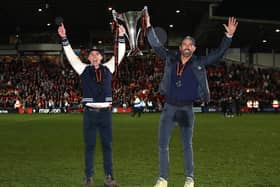 Rob McElhenney and Ryan Reynolds, the owners of Wrexham, celebrate with the Vanarama National League trophy