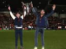 Rob McElhenney and Ryan Reynolds, the owners of Wrexham, celebrate with the Vanarama National League trophy