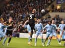 Jack Whatmough competes for a header at Coventry