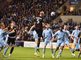 Jack Whatmough competes for a header at Coventry