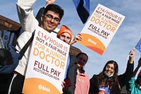 Flags and placards were waved by junior doctors on the picket line outside Wigan Infirmary last year