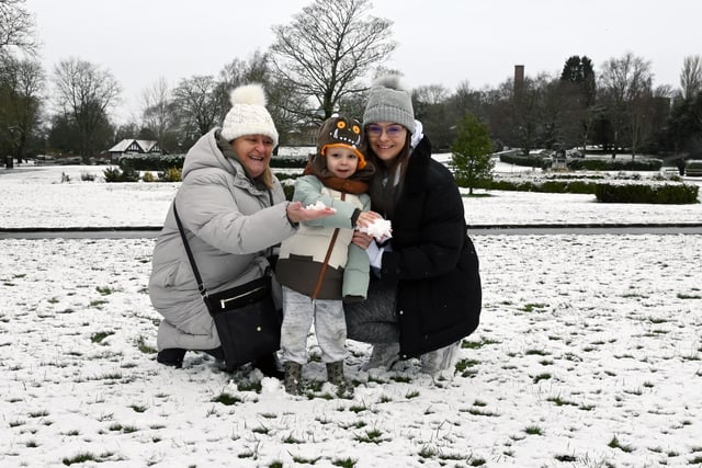 Charlie, three, has fun in the snow with nanny Khrista Coyle and mum Chloe Coyle, right.
