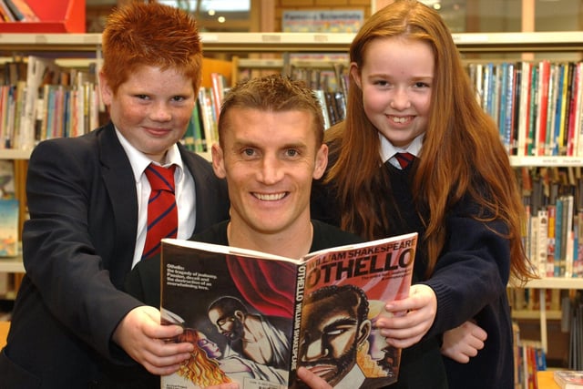 Wigan Athletic player Matt Jackson visited Standish High School to promote Own Book Week. Pictured helping Matt brush up on his Shakespeare are Robbie Lannon, and Pearl Goldsbrough.