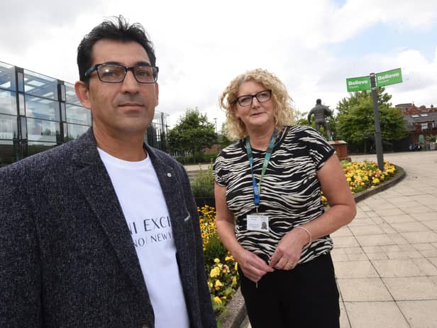 Ahmed Manocher a refugee from Afghanistan, pictured in Believe Square with Wigan Council Service Delivery Footprint manager Joanne Edwards