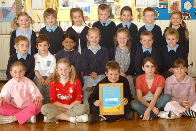 Pupils from St James Catholic Primary School with an ASDA award.