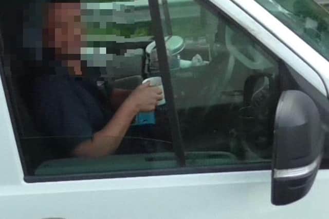 This driver took both hands off the wheel while drinking his cup of tea