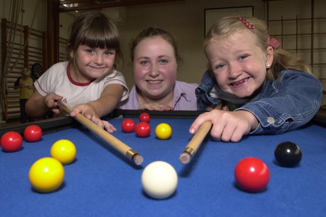 Jessica Miller, five, left, and Georgia Jackson, seven on cue at a summer play scheme held at Golborne High School with Wigan and Leigh College work experience student Stephanie Partington
