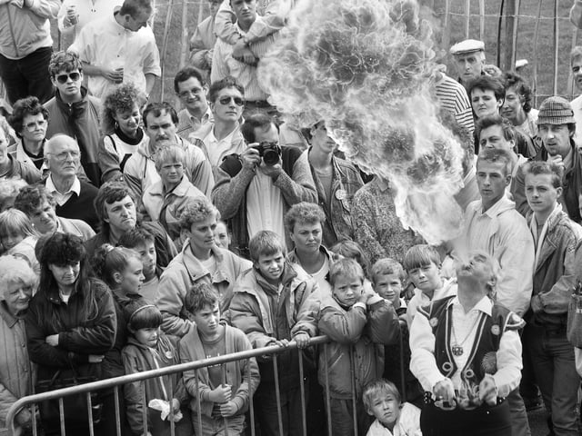 A fire-eater wows the crowds at Haigh Carnival on Bank Holiday Monday 29th of August 1988.