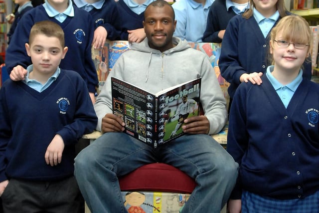 Wigan Athletic defender Emmerson Boyce visited the temporary Children's Library at The Galleries, Wigan to read stories to youngsters and play Wii. Pictured with him are, left to right: Jack, Tom, James, Edward, Daniel, Ashley, Helen and Beth.