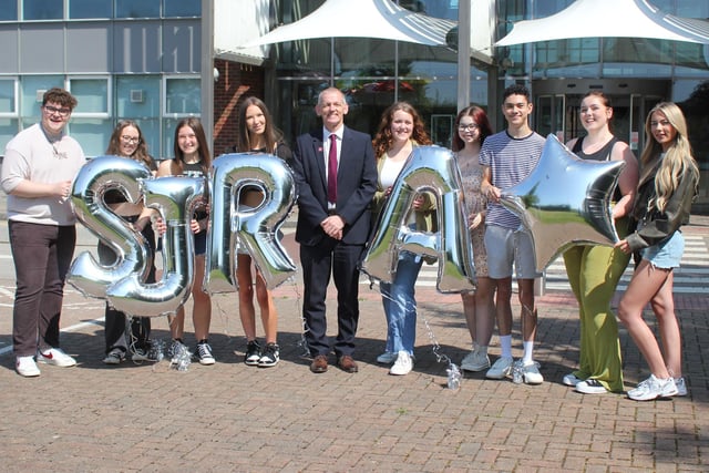 Students and principal celebrate A-Level results at St John Rigby College with principal Peter McGhee