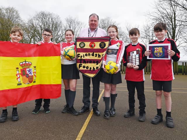 PE lead Mr Montrose with pupils at Billinge Chapel End Primary School, as they prepare to host their annual football tournament, Billinge V Barcelona.