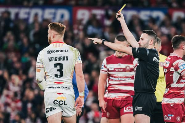 Catalans’ Adam Keighran is shown a yellow card by referee Liam Moore after a dangerous tackle on Wigan’s Kai Pearce-Paul