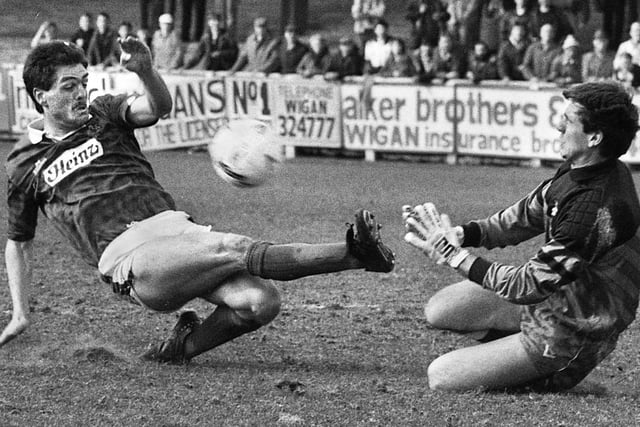 Wigan Athletic forward Mark Hilditch challenges the Bristol City goalkeeper in a Division 3 match at Springfield Park on Saturday 7th of April 1990.
Latics lost the game 2-3 with Ian Baraclough and Joe Parkinson getting the goals.